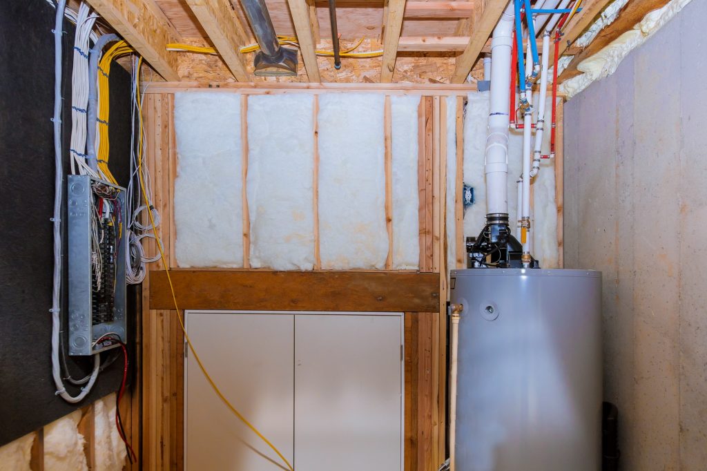 Boiler and pipes of the heating system a home framing with basement